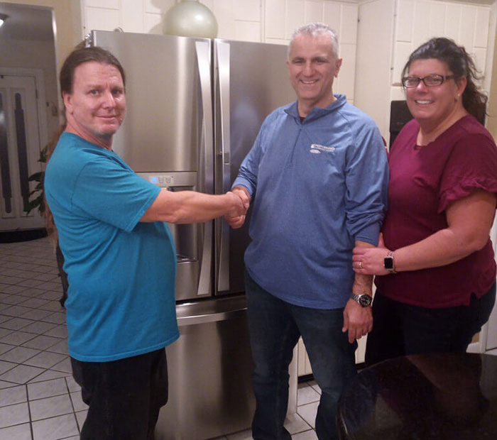 Happy customers shaking with Dan